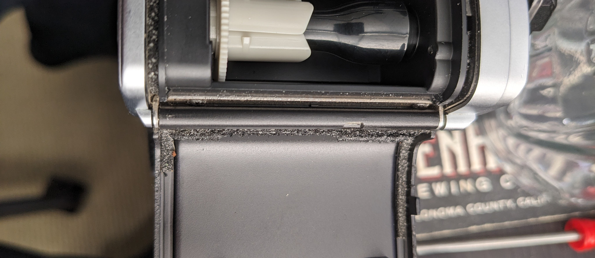Before the Repair: Crumbling foam lines the camera hinge